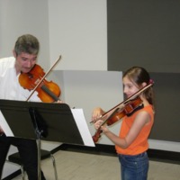 Alexandra King taking a violin lesson in Mexico, c. 2006.