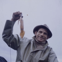 A Fisherman Displaying his First Squid of the Season