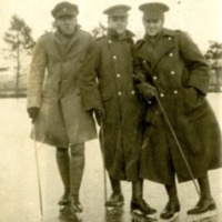 Three men in Royal Newfoundland Regiment uniforms on ice skates