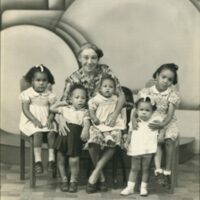 COLLINS-Emily-Aida-w-grandchildren-scaled (1).jpg